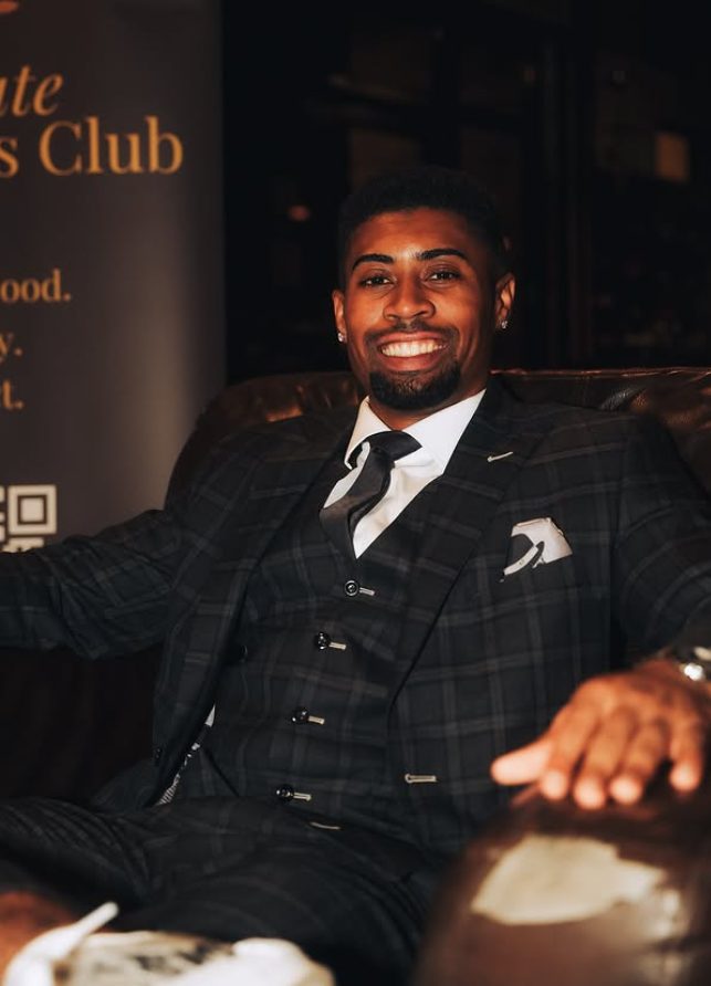 A member relaxed in a leather chair at an event
