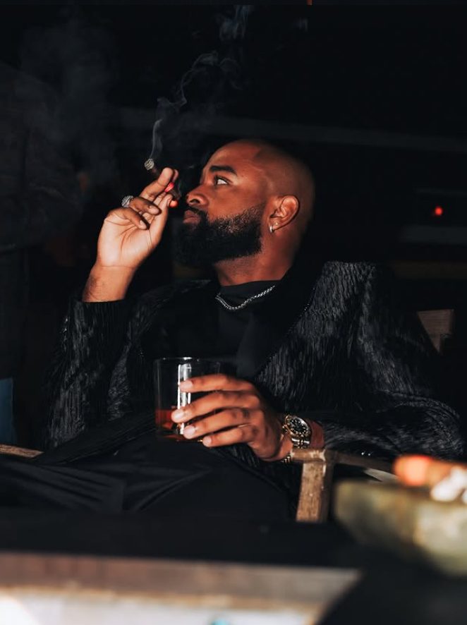 A member with a whiskey and cigar